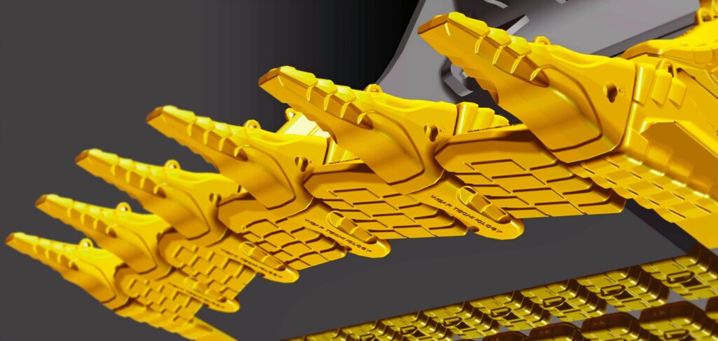 Жовті металеві зуби будівельної машини в крупному плані.